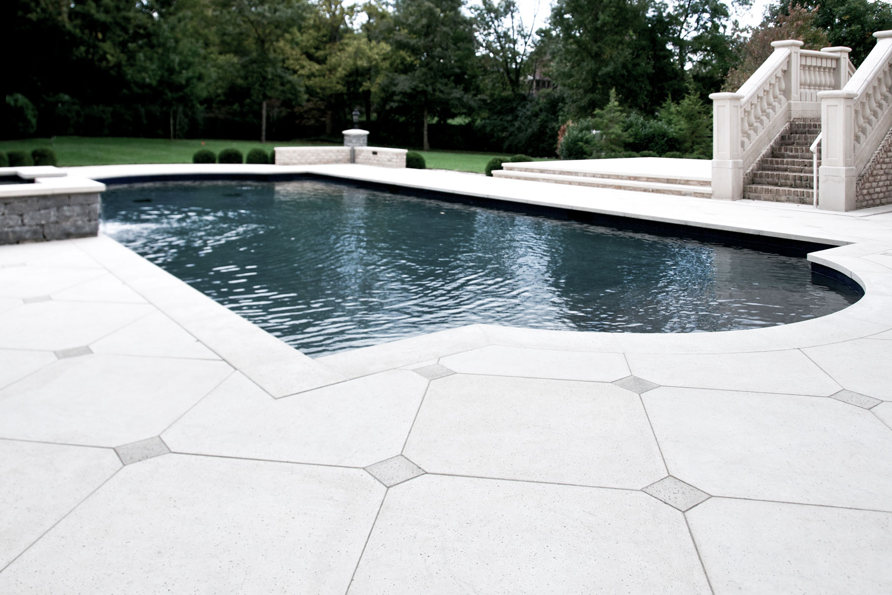 These custom pool coping tiles and pavers around pool fit to its unique shape