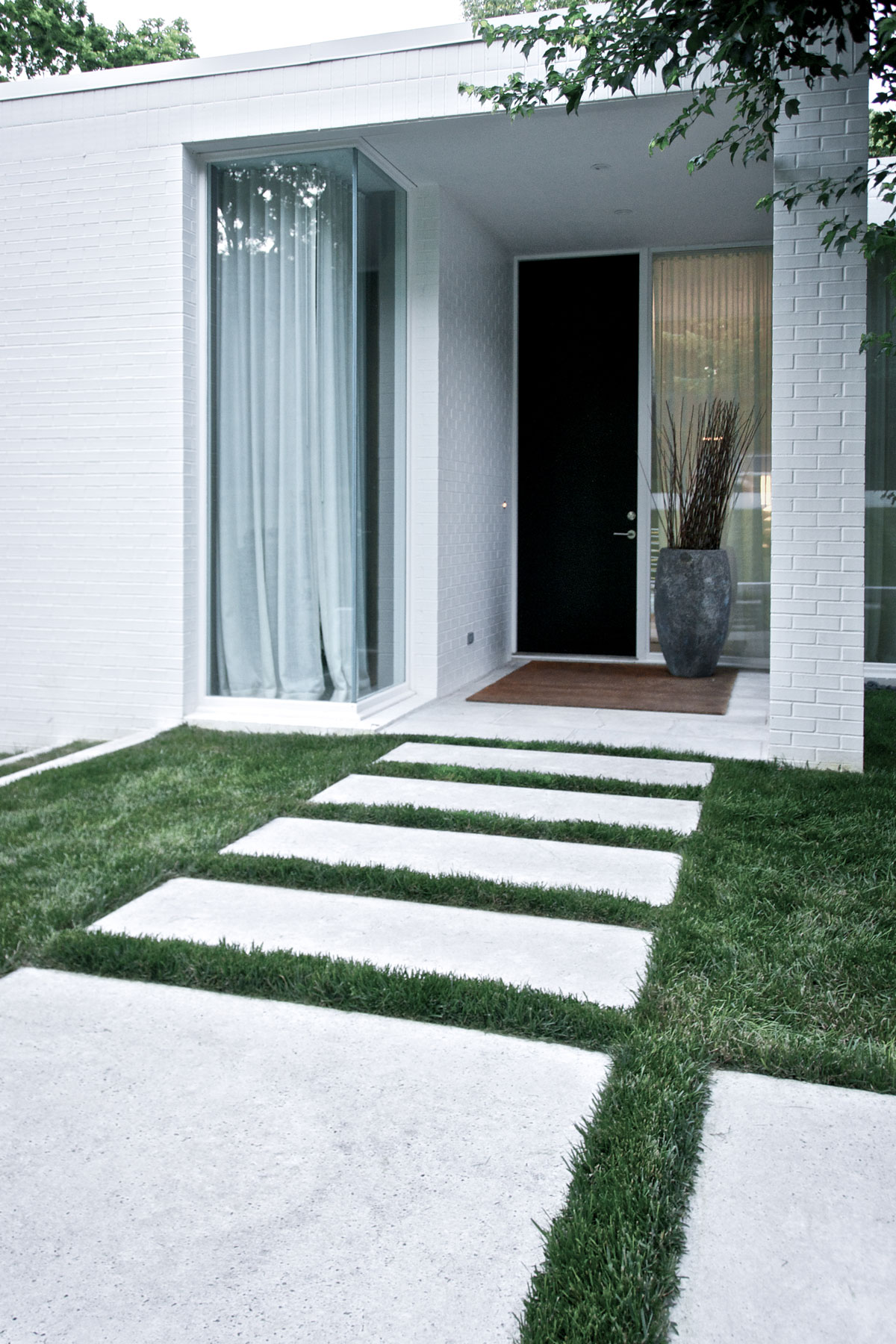 Flat patio pavers make excellent stepping stones for grassy walkways