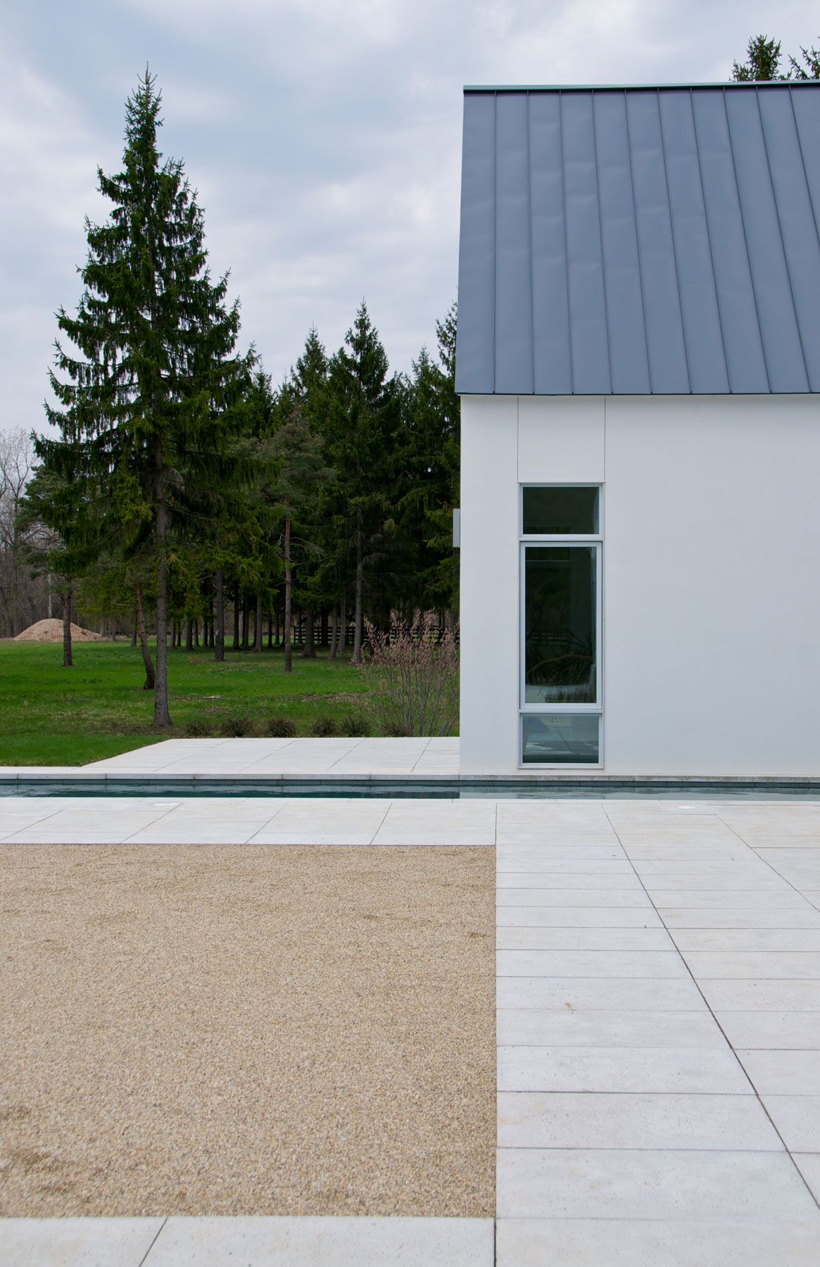The minimalist deck pavers match the property siding