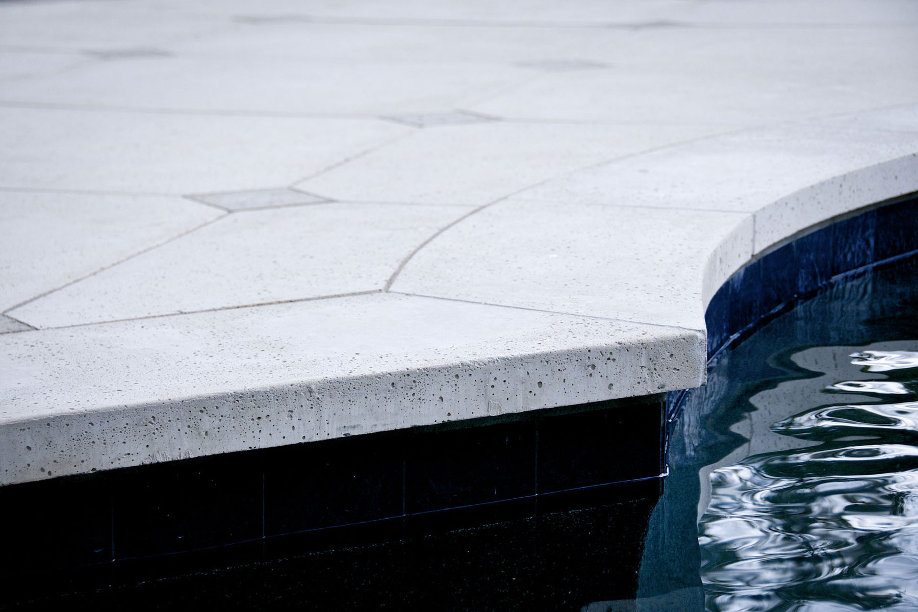 The pool coping tiles are smoothed for comfort, but still have naturalistic stone texture