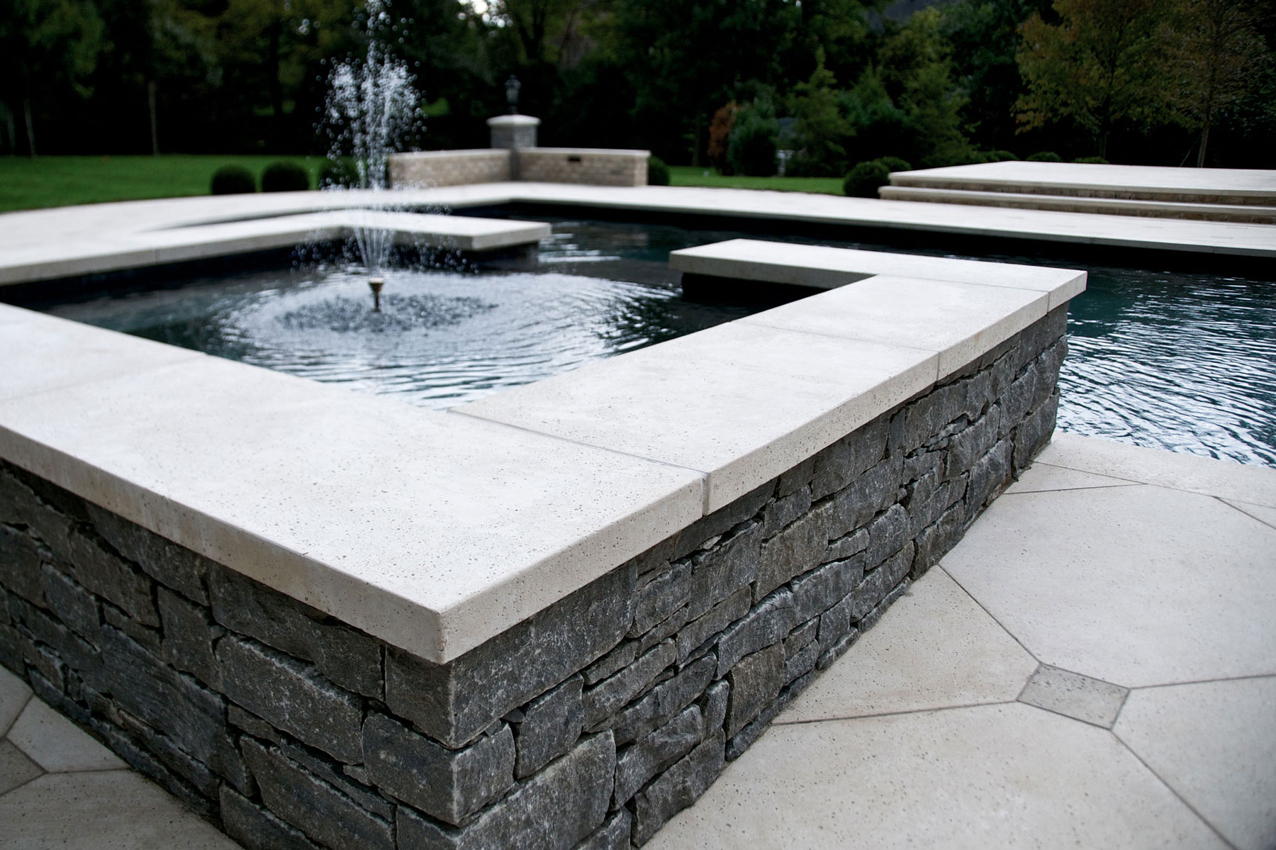 Matching coping pavers are also on the fountain next to the pool