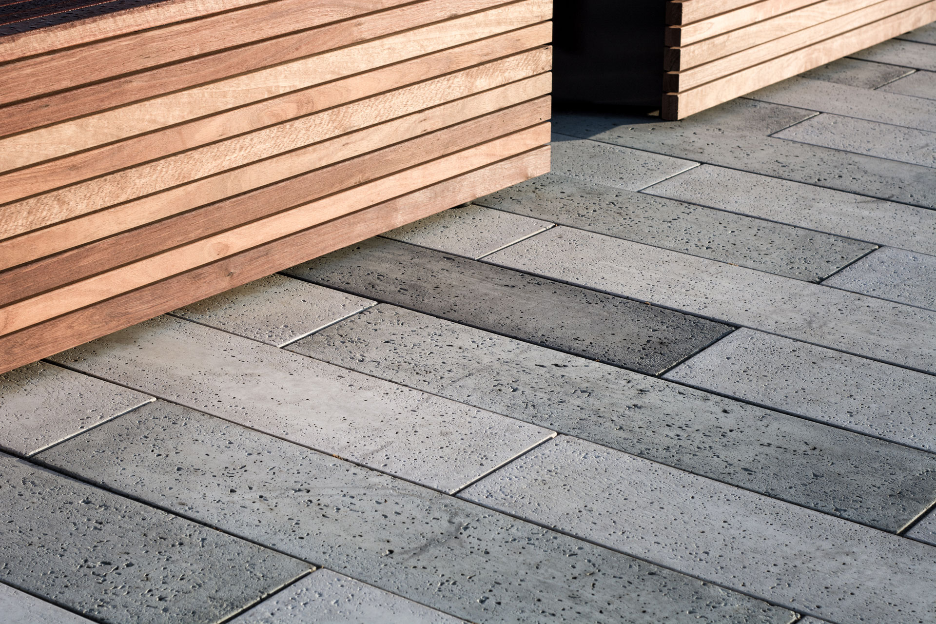 Rectangle pavers in multiple paver colors mimic the bench design of the park