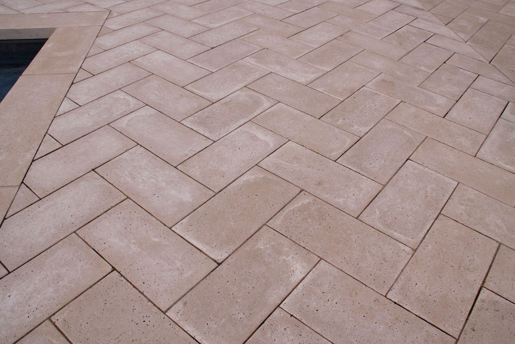 the hardscape is mostly made of herringbone flooring in tan concrete