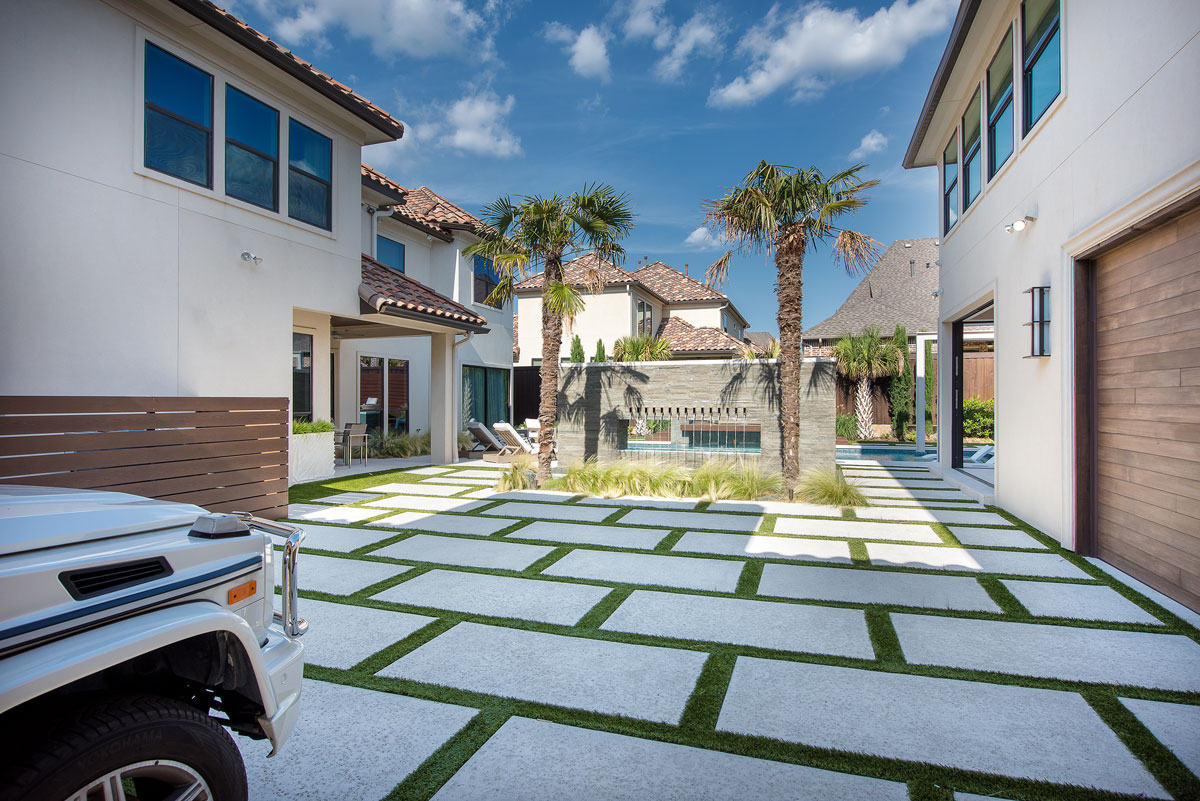 These offset deck pavers extend beyond just the poolside and let some grass into the space