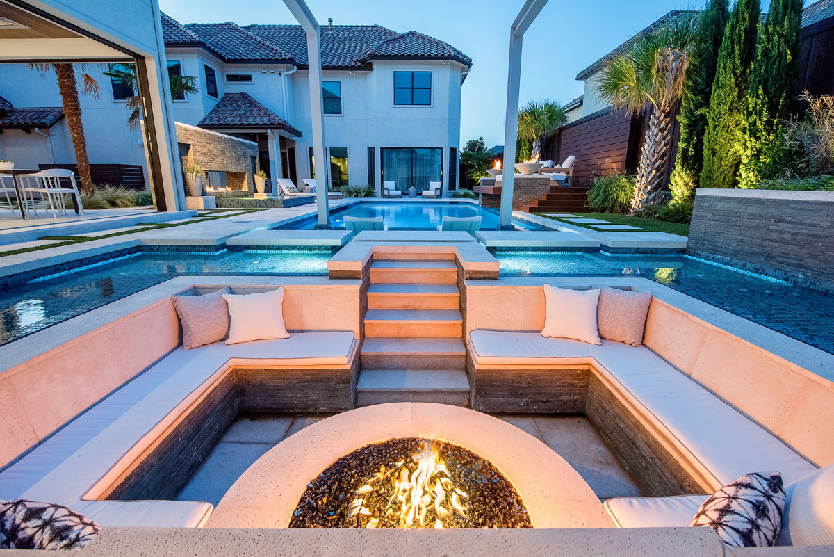 The backyard entertainment space is aligned with the pool deck pavers of the swimming pool