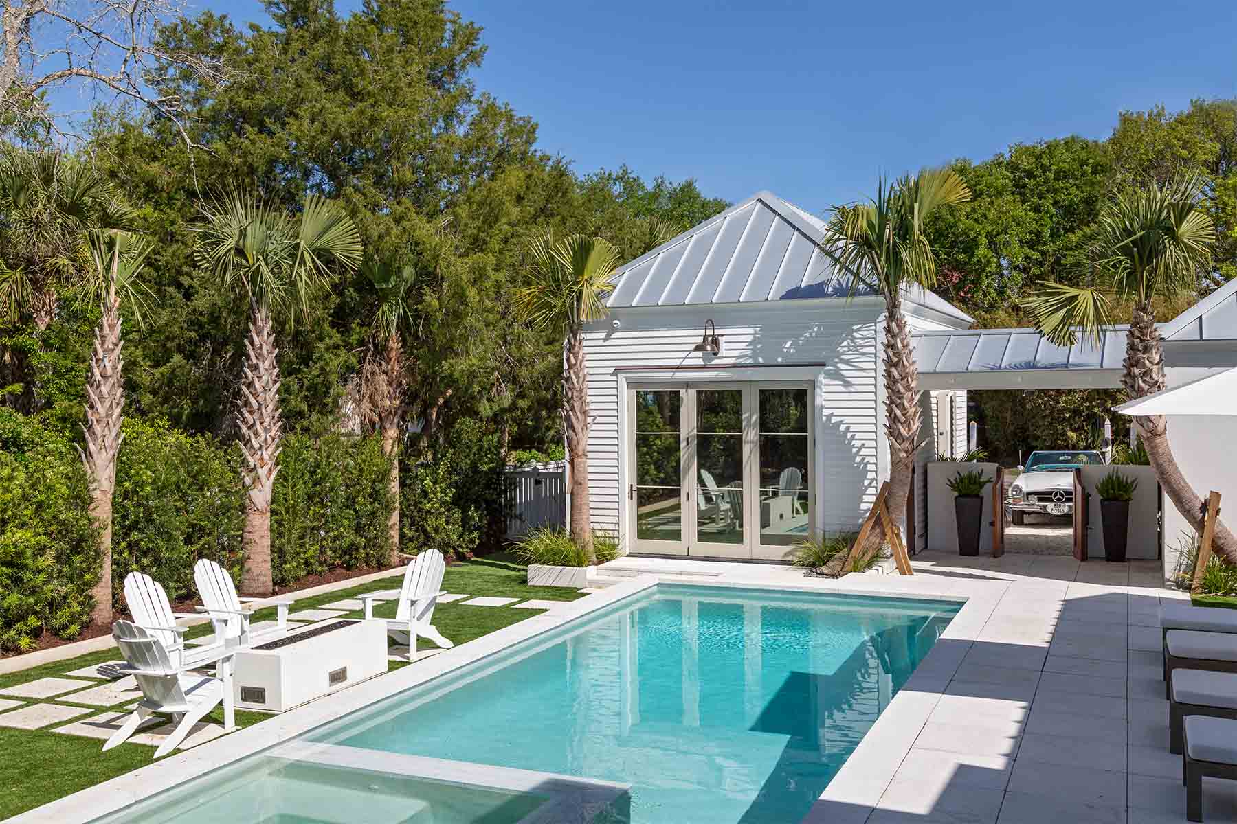 This Refurbished home features a backyard oasis amongst the sullivan's island landscape