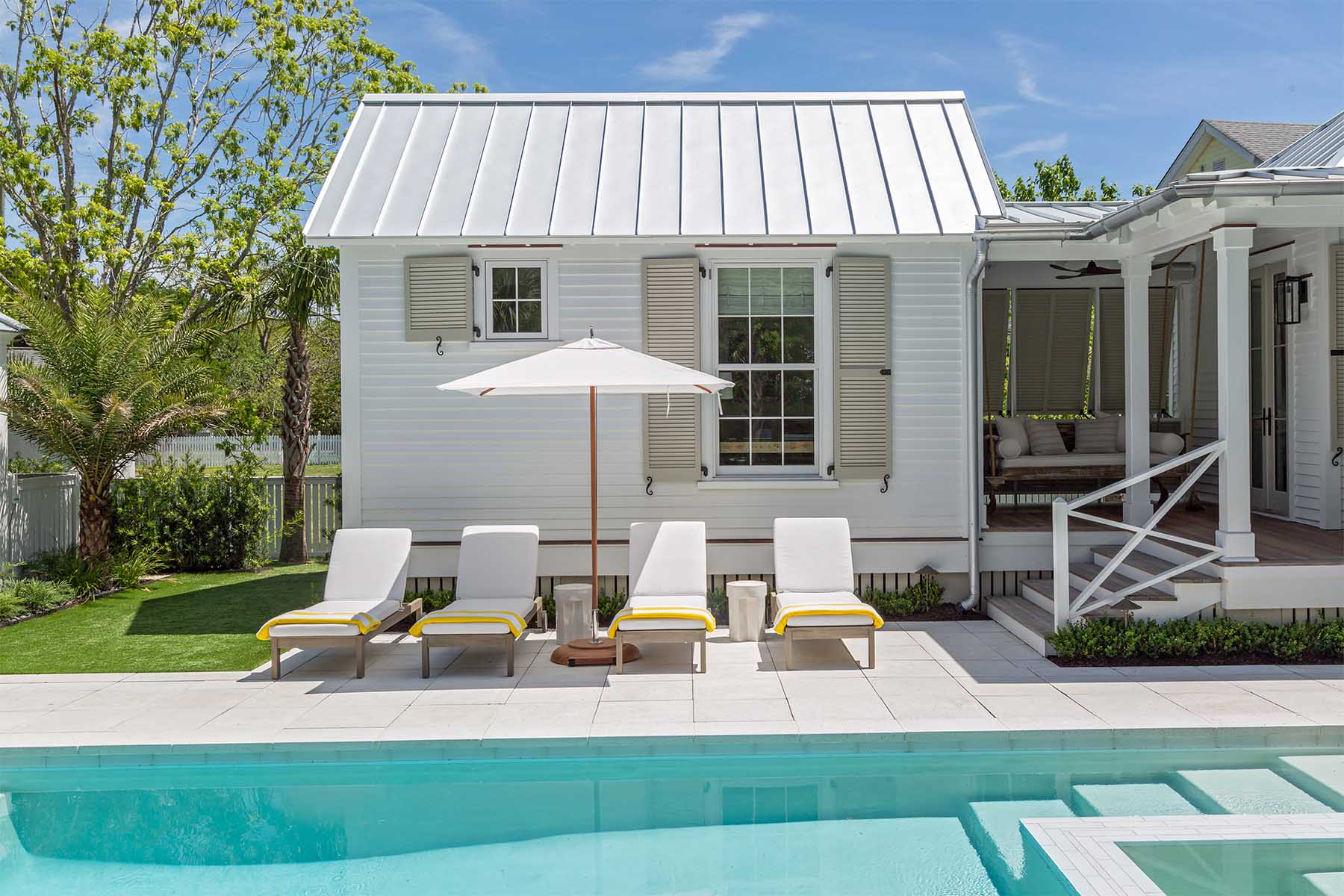 The step pavers at this refurbished home merge into the pool tiles