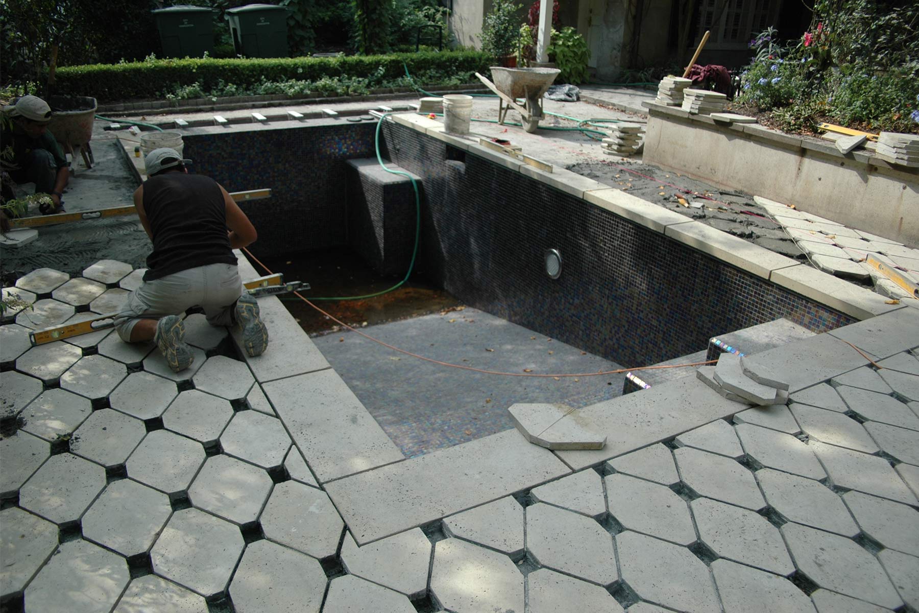 The team installs the pool deck designs